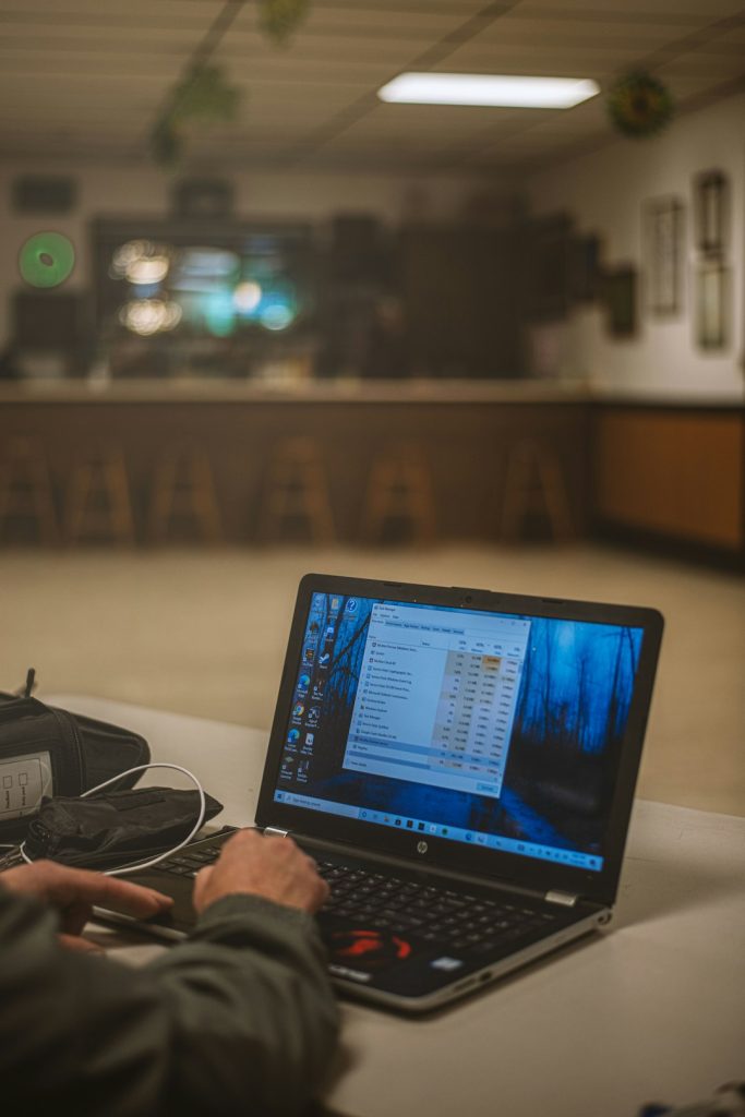 a-man-sitting-at-a-table-using-a-laptop-computer-ezmoa2mv0nc